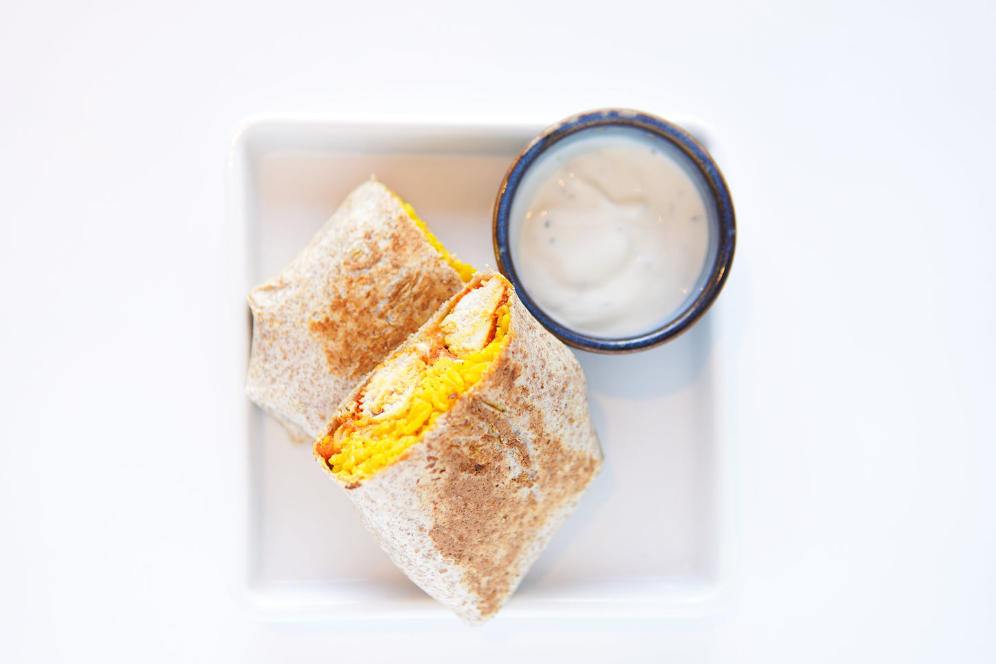 Chicken Tikka Burrito with a Zesty Sour Cream Dip.